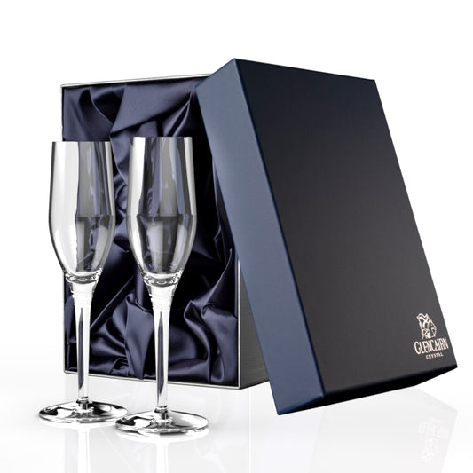 Two sleek yet elegant champagne flutes made of lead-free crystal in a luxurious blue presentation box.