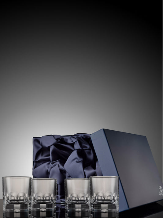 Set of four Lewis crystal whisky tumblers in a blue satin box.